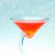 red cocktail with petal background